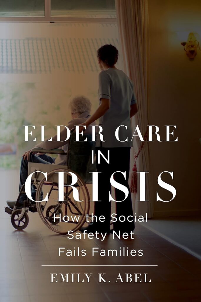 An elderly person on a wheelchair is being pushed by a uniformed caretaker inside a home